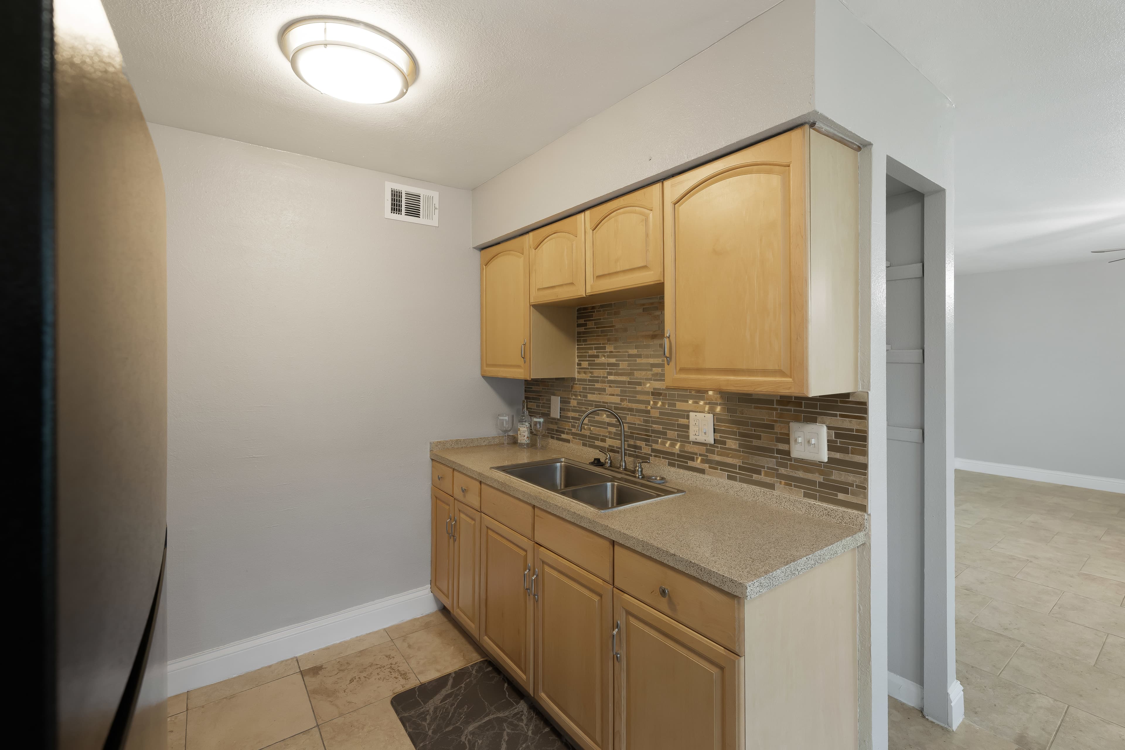 Waverly kitchen cabinetry, backsplash, counter and double sink