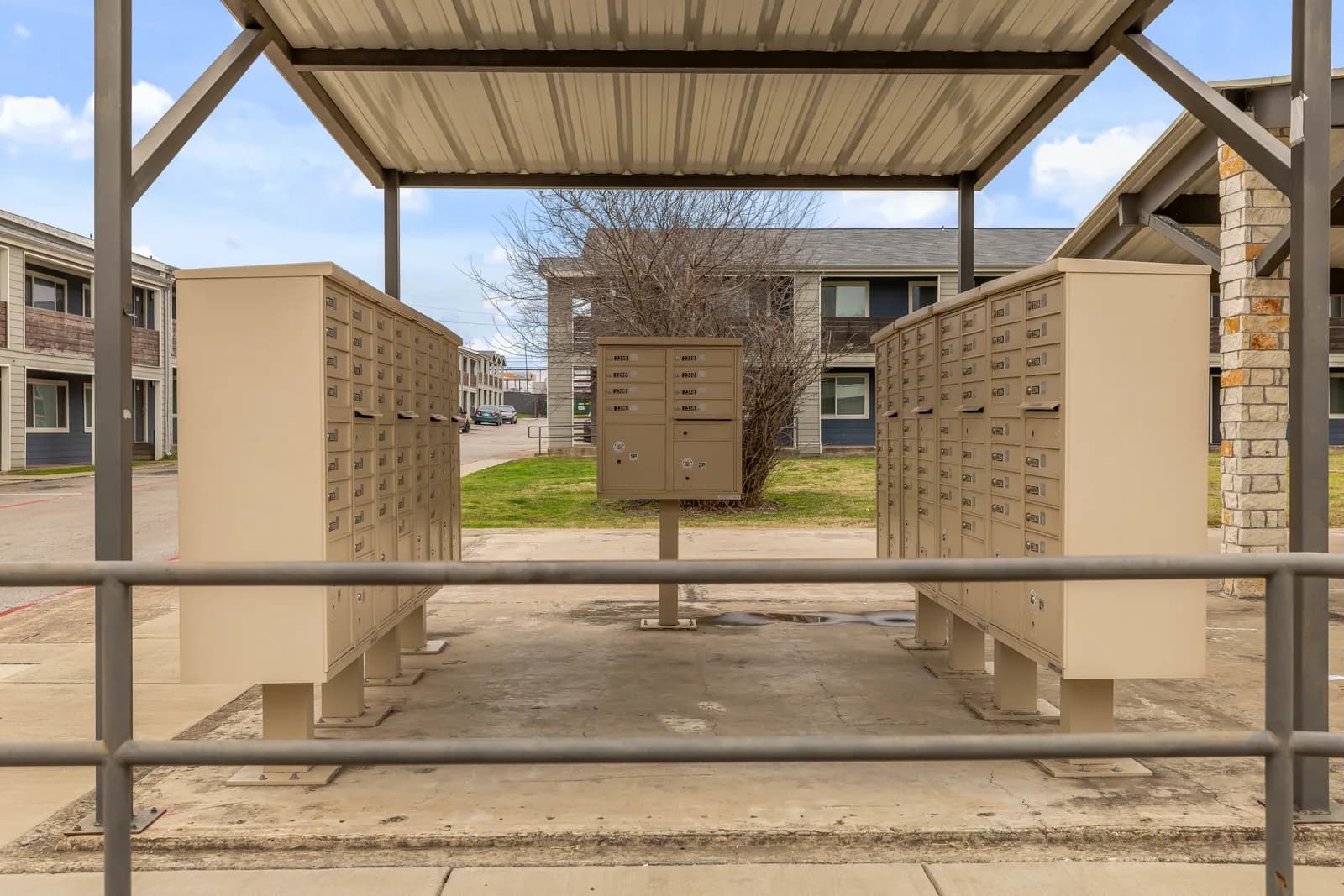 Covered community mailboxes between Waverly apartment buildings