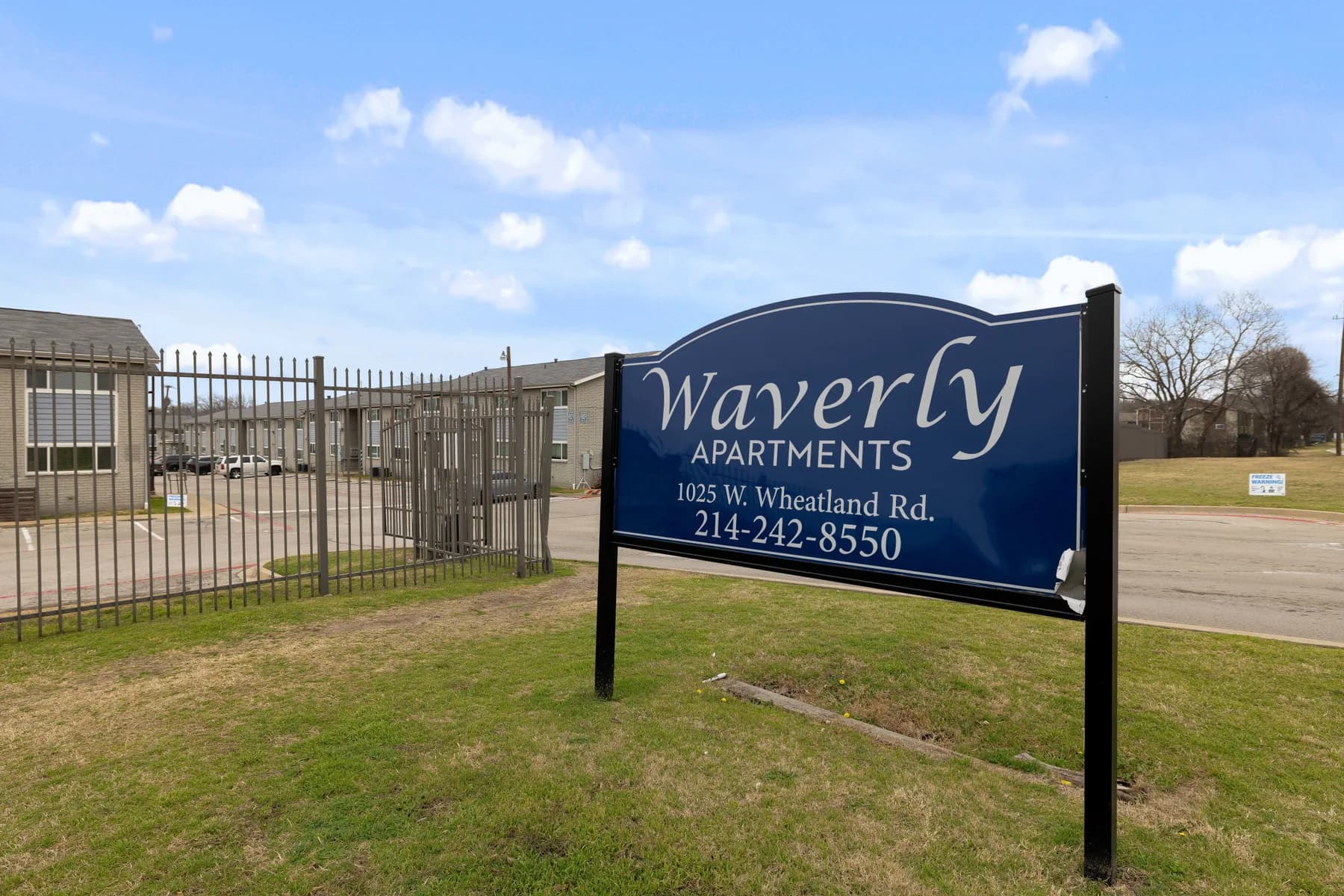 Waverly Apartments sign displaying the property address and leasing phone